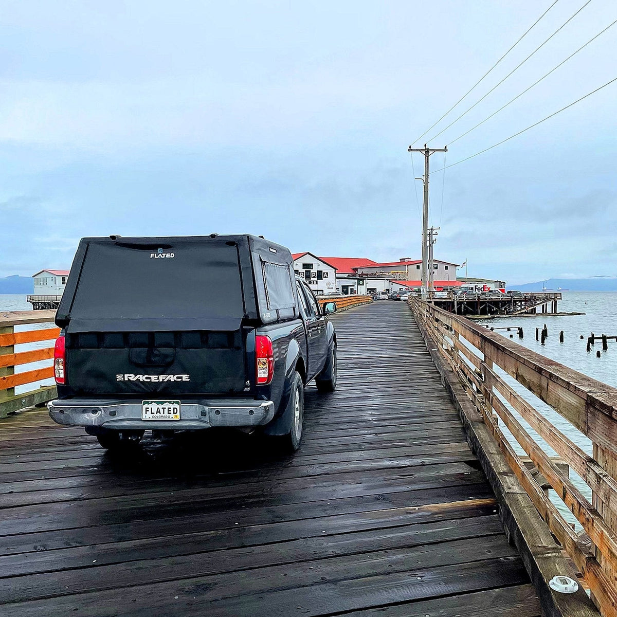 A truck taking the topper on a pier with the Air-Topper™ Mid-Size - GETFLATED